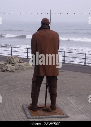 Filey Fisherman Statue - High Tide in Short Wellies - Ray Lonsdale Steel Statue - Filey Seafront - North Yorkshire UK Stock Photo