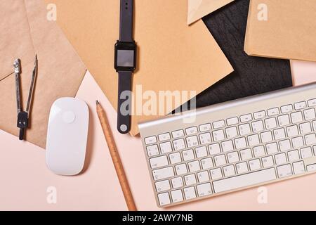 Horizontal from above flat lay conceptual shot of mess on office table, pale pink background Stock Photo