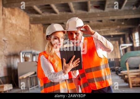 Engineers in wooden factory working on digital tablet Stock Photo
