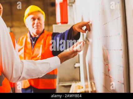 The engineers are discussing the details of the work Stock Photo