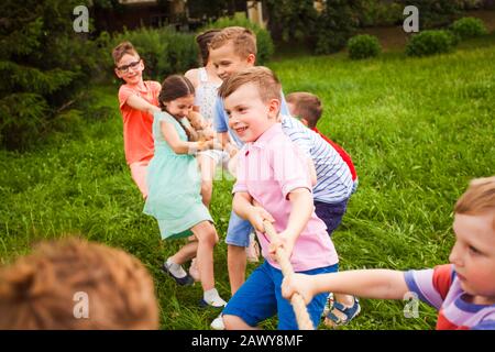 The happy kids having fun and workout in the park Stock Photo