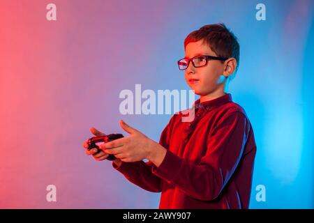 Boy using a gaming gadget for virtual reality in playing game zone Stock Photo