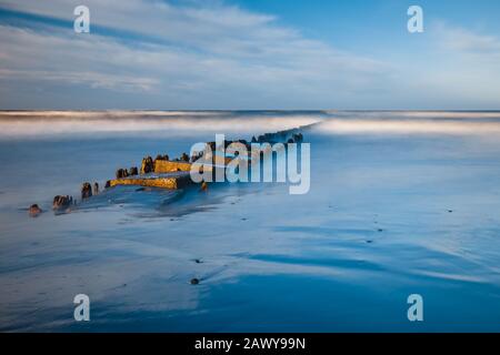 Long exposure shot of the sea and a pier in a sunset, Baltic Sea, Poland Stock Photo