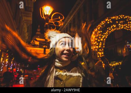 Happy girl look around at the christmas market Stock Photo