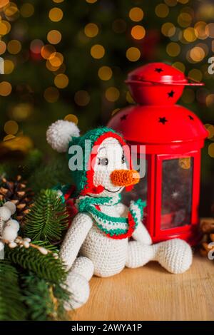 Knitted snowman toy under the Christmas tree Stock Photo