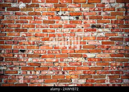 Weathered texture of dark brown and red brick wall background Stock Photo