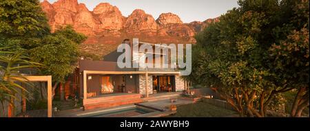 Mountains behind modern, luxury home showcase exterior house Stock Photo