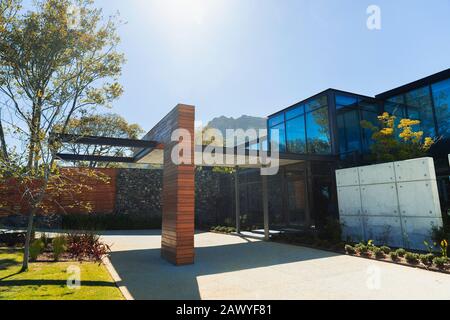 Sunny modern luxury home showcase exterior with infinity pool and ocean ...