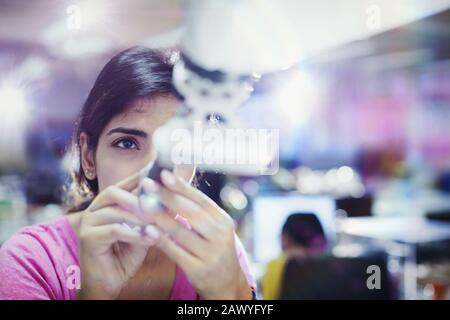 Focused female engineer repairing robotic arm Stock Photo