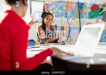 Female interior designers discussing wood swatches in conference room meeting Stock Photo