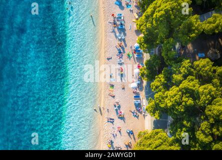 Aerial view of sandy beach with colorful umbrellas, blue sea sea Stock Photo