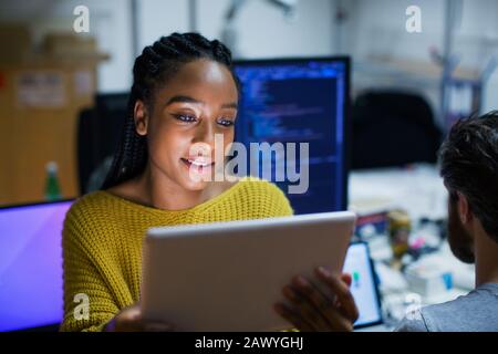 Female computer programmer using digital tablet in office Stock Photo