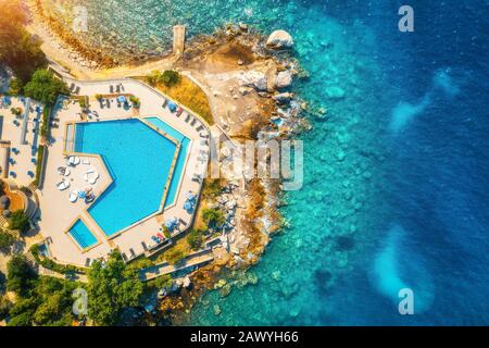 Aerial view of pool, beach with green trees and blue sea Stock Photo