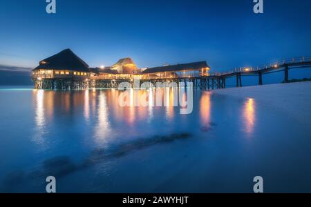 Beautiful wooden restaurant on the water in summer night Stock Photo