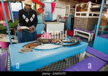 Morocco , Africa, January 16, 2020: fisherman displays his catch in Marocco. Is a major tourist destination renown for it's seafood. Stock Photo