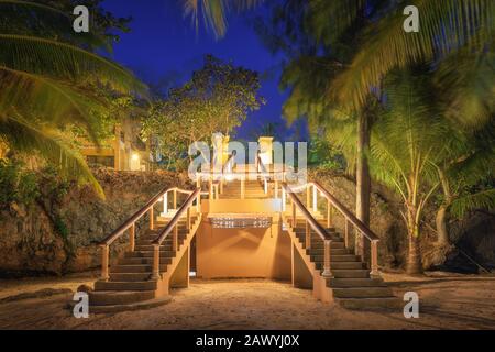 Lighted stairs in beautiful tropical forest at summer night Stock Photo