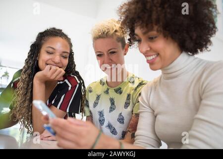 Young women friends using smart phone Stock Photo