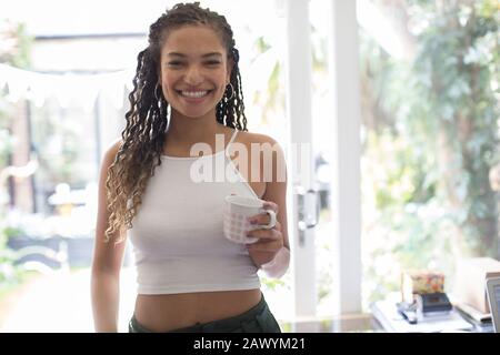 Portrait confident young woman drinking coffee Stock Photo