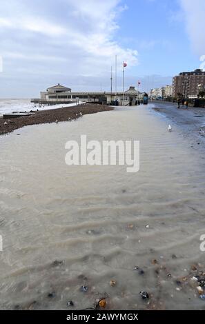 Shoreham UK 10th February 2020 - Worthing seafront promenade is flooded after the sea came over at high tide today as the tail end of Storm Ciara blows through Britain : Credit Simon Dack / Alamy Live News Stock Photo