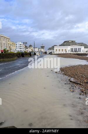 Shoreham UK 10th February 2020 - Worthing seafront promenade is flooded after the sea came over at high tide today as the tail end of Storm Ciara blows through Britain : Credit Simon Dack / Alamy Live News Stock Photo