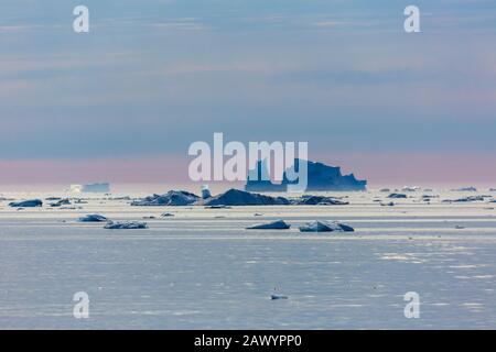 Melting icebergs over tranquil Atlantic Ocean Greenland Stock Photo