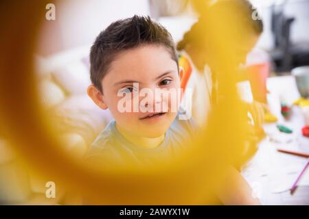 Portrait cute boy with Down Syndrome playing Stock Photo