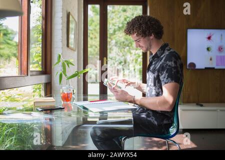 Young man with digital tablet working in home office Stock Photo