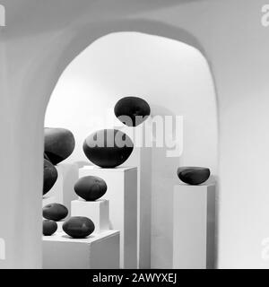 Greyscale of clay objects under the lights against a white background Stock Photo