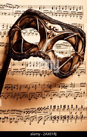 Venetian carnival mask and music score Stock Photo