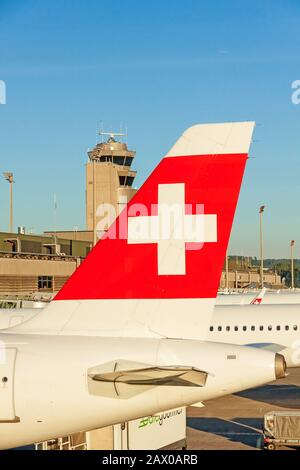 Zurich, Switzerland - June 11, 2017: Airport Zurich - airplane tail fin of airline 'Swiss' plane / tower in background Stock Photo