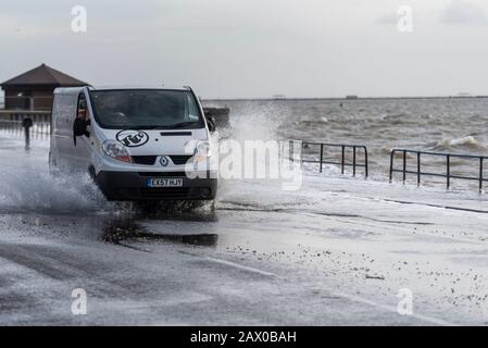 Southend on Sea, Essex, UK. 10th Feb, 2020. The tail end of storm Ciara combined with a high tide has breached the sea defences along the town's Western Esplanade causing a road closure after some traffic braved the water. Van driving through flooding Stock Photo