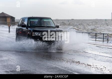 Southend on Sea, Essex, UK. 10th Feb, 2020. The tail end of storm Ciara combined with a high tide has breached the sea defences along the town's Western Esplanade causing a road closure after some traffic braved the water. Range Rover driving through flood water Stock Photo