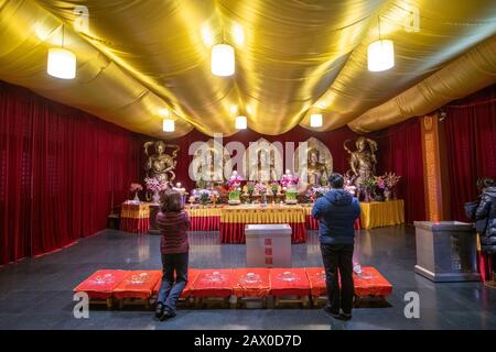 People praying at an altar in the Jing'an Temple , Shanghai, China Stock Photo