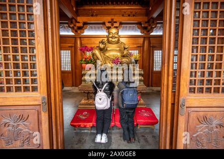 People praying at an altar in the Jing'an Temple , Shanghai, China Stock Photo