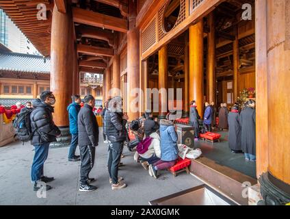 People praying at an altar in the Jing'an Temple , Shanghai, China Stock Photo