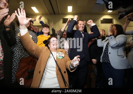 Dublin, Ireland. 9th Feb, 2020. General Election 2020. Counting of votes. Man of the moment Paul Donnelly of Sinn Fein celebrates with his mother Bridie (left), and family and supporters after being elected on the first count in the count centre in the Phibblestown Community Centre in Dublin West. He came in ahead of the Taoiseach Leo Varadkar, who was only elected on the 5th count. Photo: Eamonn Farrell/RollingNews.ie/Alamy Live News Credit: RollingNews.ie/Alamy Live News Stock Photo