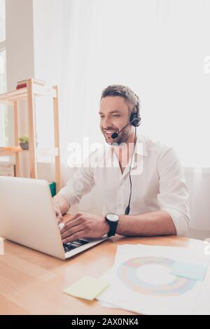 Portrait of young man in headphones working in call center Stock Photo