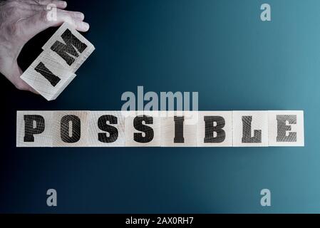 changing word impossible to impossible on wooden blocks, motivation and inspiration concept Stock Photo