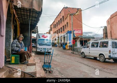 Tighedouine, Morocco - January 16, 2020: Main street of Tighedouine with regular human and car traffic Stock Photo