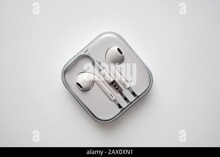 White plastic earphones in square container isolated from a high angle view Stock Photo