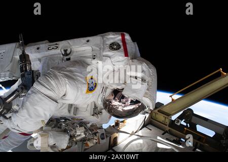 ISS - 20 Jan 2020 - The reflection in NASA astronaut Jessica Meir's spacesuit helmet is fellow NASA astronaut Christina Koch photographing her crewmat Stock Photo