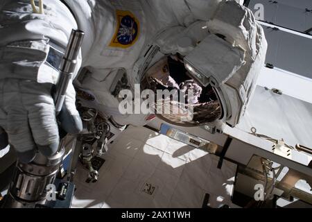 ISS - 20 Jan 2020 - The reflection in NASA astronaut Jessica Meir's spacesuit helmet is fellow NASA astronaut Christina Koch photographing her crewmat Stock Photo