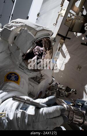 ISS - 20 Jan 2020 - The reflection in NASA astronaut Jessica Meir's spacesuit helmet is fellow NASA astronaut Christina Koch photographing her crewmat Stock Photo