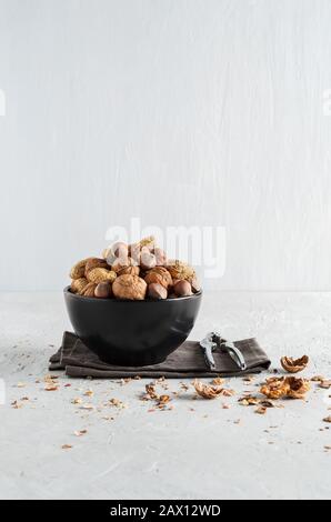 Peanuts and nuts in a bowl on a delicate background Stock Photo