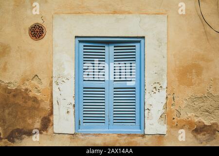 old rustic window with grey closed shutters in Mallorca, Spain Stock Photo