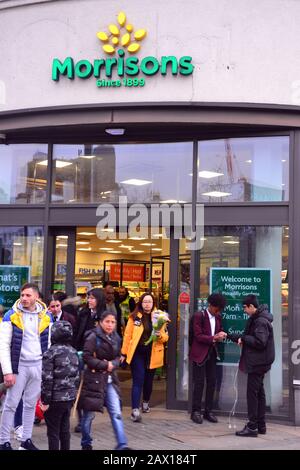 The entrance to Morrisons supermarket,19-25 Piccadilly, Manchester M1 1LU, United Kingdom, where media report that two men were stabbed nearby on 10th February, 2020. There was a large police response and the area was cordoned off while a forensics officer investigated. The police have said they believe this was a targeted attack. Media report that the victims were a father and son. Stock Photo