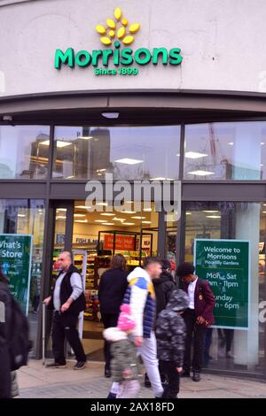 The entrance to Morrisons supermarket,19-25 Piccadilly, Manchester M1 1LU, United Kingdom, where media report that two men were stabbed nearby on 10th February, 2020. There was a large police response and the area was cordoned off while a forensics officer investigated. The police have said they believe this was a targeted attack. Media report that the victims were a father and son. Stock Photo