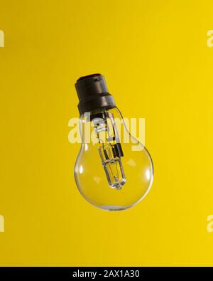 Clean Lightbulb on Yellow Background Stock Photo