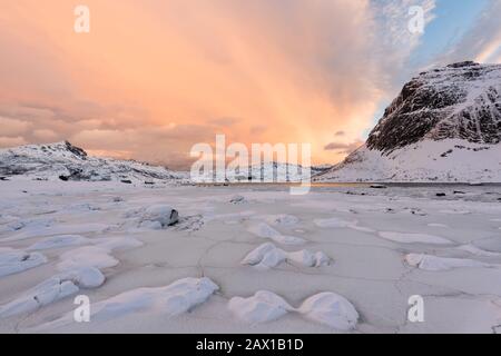 Lofoten Islands in Norway and their beautiful winter scenery at sunset. Idyllic landscape with snow covered beach. Tourist attraction in the arctic ci Stock Photo