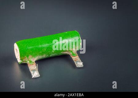 Very old ceramic electronic resistance against a dark background. Stock Photo